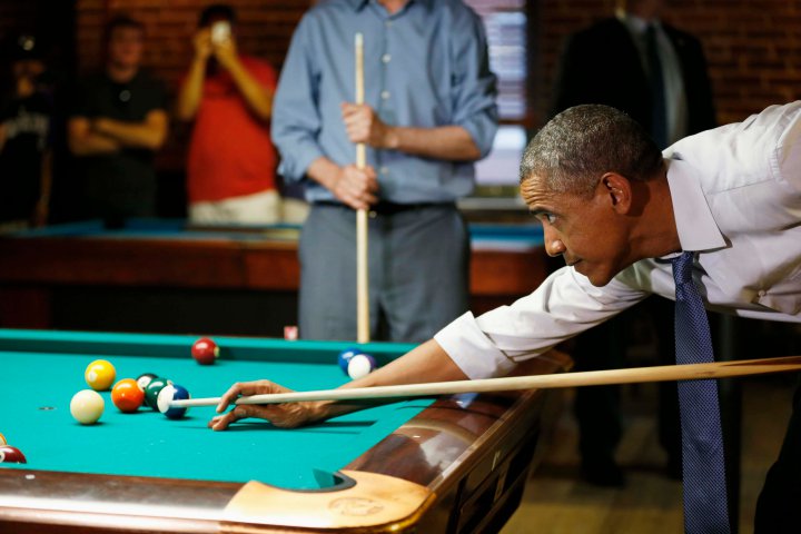 U.S. President Barack Obama shoots pool during a stop in a bar in Denver