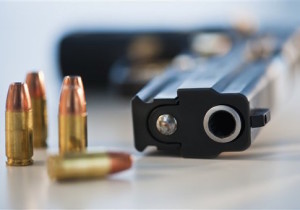 A handgun and ammunition (Photo by: Tetra Images/AP Images)