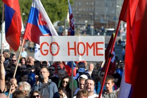 TOPSHOTS Participants hold flags and a banner during an anti-immigration rally organised by an initiative called "Stop Islamisation of Europe" and backed by the far-right "People's Party-Our Slovakia" on September 12, 2015 in Bratislava, Slovakia. AFP PHOTO / Samuel Kubani