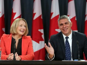 NDP industry critic Peggy Nash, left, and NDP candidate shares a laugh with fellow candidate Andrew Thomson about Finance Minister Joe Oliver during a news conference in Ottawa, Tuesday September 1, 2015. THE CANADIAN PRESS/Fred Chartrand