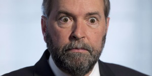 NDP Leader Tom Mulcair gets expressive as he responds to questions with the media following a party caucus meeting on Parliament Hill Wednesday May 8, 2013 in Ottawa. THE CANADIAN PRESS/Adrian Wyld