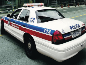 WARNING: CMYK IMAGE. DO NOT USE FOR NORMAL OUTPUT OR WEB. ONLY FOR USE FOR NATIONAL POST CLOSECROP IN PRINT  //NPCLOSECROP// TORONTO, ONTARIO: SEPTEMBER 6, 2011 - A police car blocks traffic on Bay Street after glass fell from a condo building at the corner of Bay Street and Grosvenor Street in Toronto, Ontario, Tuesday, September 6, 2011. There have been multiple incidents of glass falling from condo buildings around the city this summer and this is not the first time glass has fallen form this complex.  (Tyler Anderson/National Post)  (For National) //NATIONAL POST STAFF PHOTO