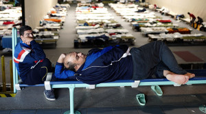 Migrants rests at an improvised temporary shelter in a sports hall in Hanau, Germany, September 29, 2015. When the flood of Middle Eastern refugees arriving in Europe finally ebbs and asylum-seekers settle down in their new homes, Germany could unexpectedly find itself housing the continent's largest Muslim minority. REUTERS/Kai Pfaffenbach - RTS29BH