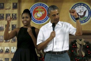 U.S. President Barack Obama and first lady Michelle Obama gesture as they arrive to deliver remarks at a Christmas reception with service members at Marine Corps Base Hawaii in Kaneohe Bay, Hawaii December 25, 2015. REUTERS/Jonathan Ernst